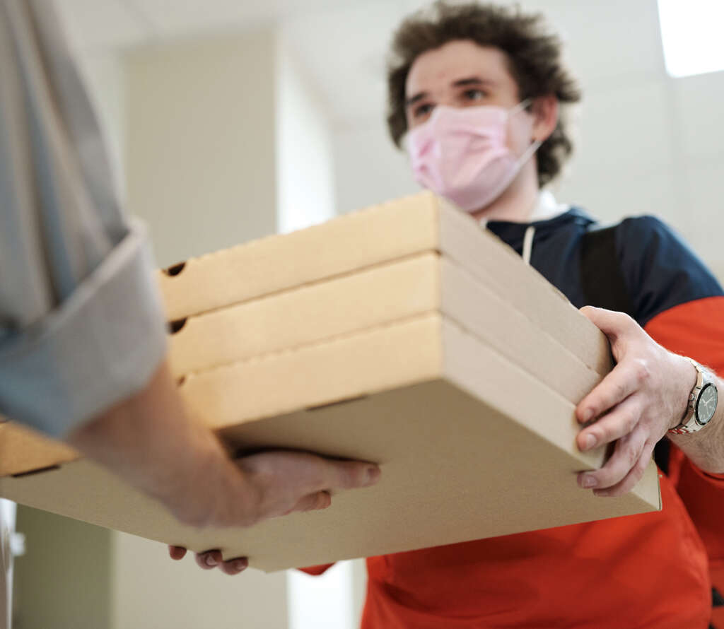 Frontline worker receives delivery pizzas