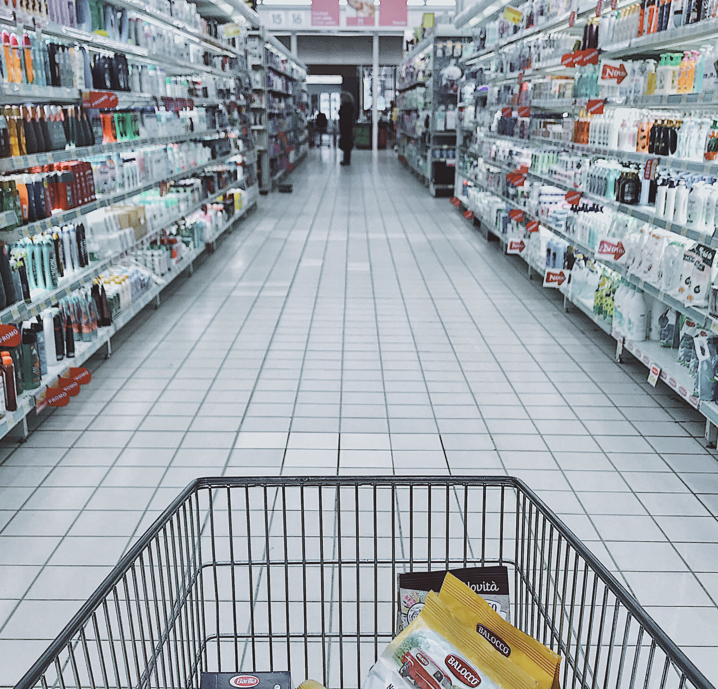 Shopping cart in lighted store aisle