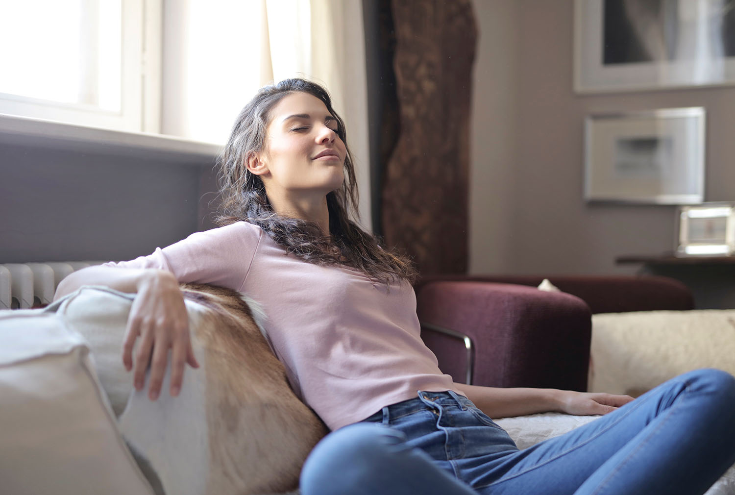 Woman relaxing on sofa and breathing deep