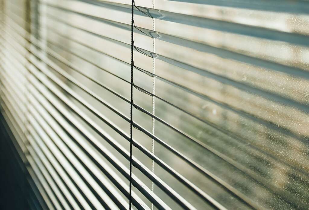 Dusty blinds in the evening sun
