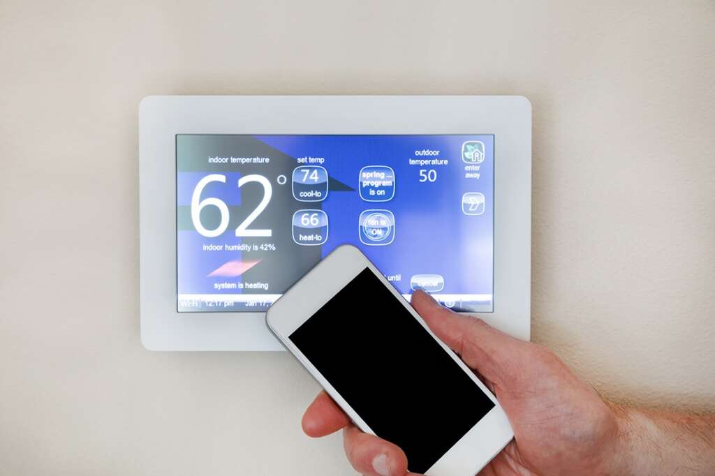 IOT Man controls programmable thermostat with smart phone