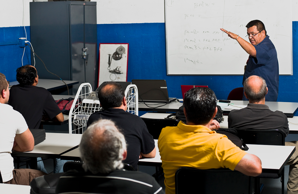An instructor leads a vocational training course for skilled tradesmen