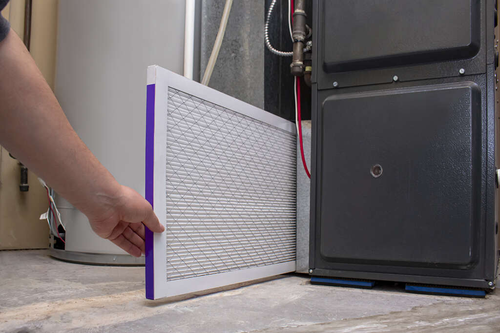 Man changing furnace air filter