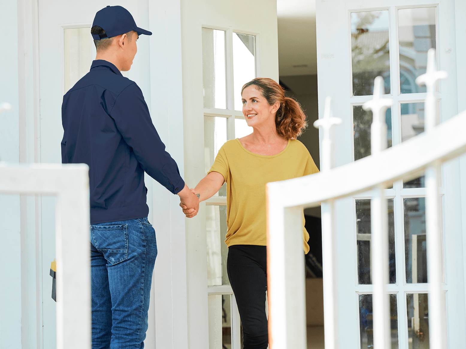 Homeowner greets her AAH HVAC Technician for her regularly scheduled maintenance under her service agreement with All American Heating